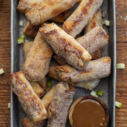 Apple Pie Egg Rolls in a Pan with Caramel Sauce and Green Apples. Dessert Egg Rolls, Apple Egg Rolls, Apple Pie Egg Rolls, Easy Apple Pie Recipes, Dessert, Air Fryer Apple Pie Egg Rolls, Oven Apple Pie Egg Rolls, Super Bowl Desserts, Thanksgiving Desserts, Christmas Desserts, Snacks, i am baker, iambaker