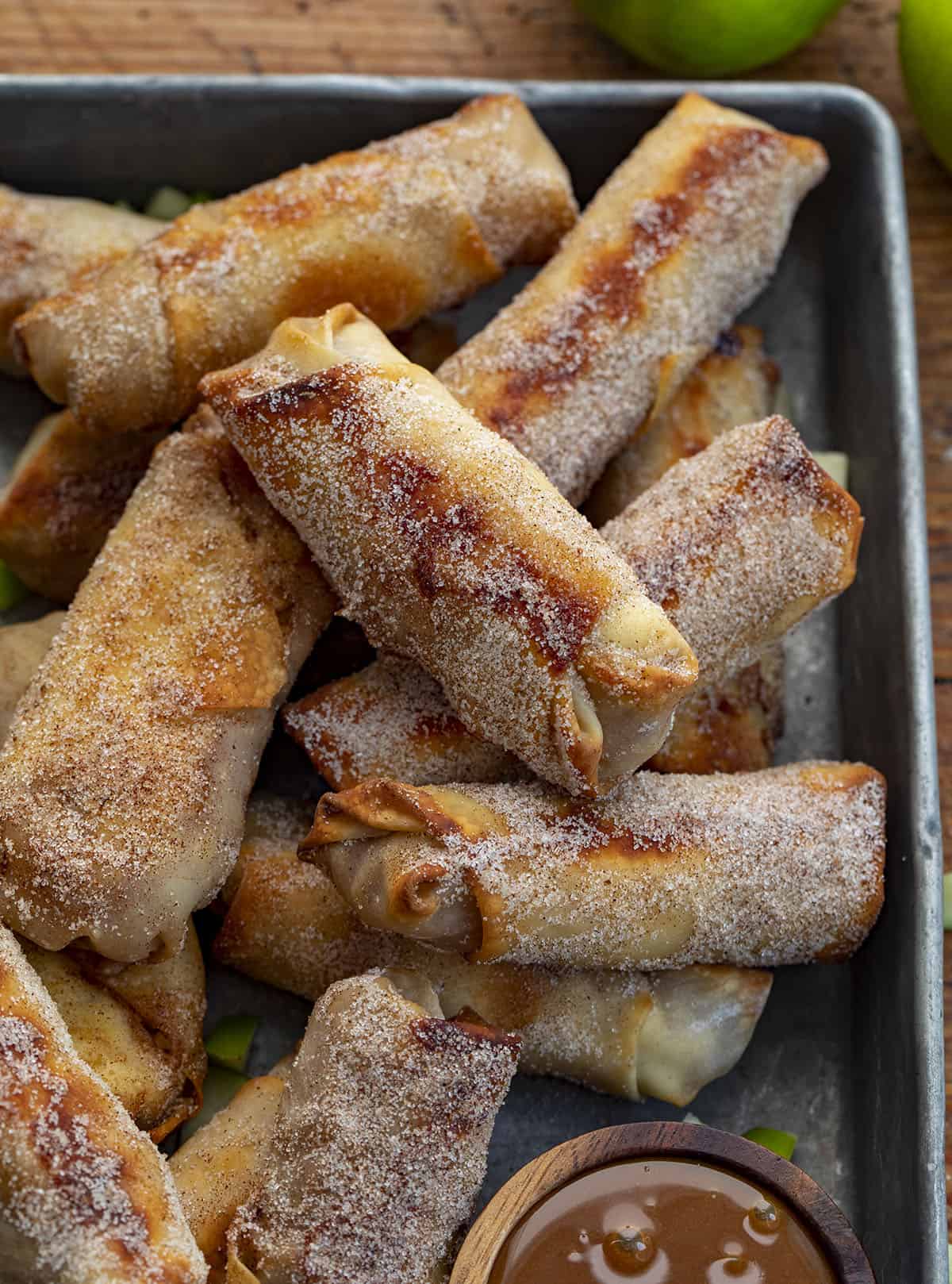 Close up of Oven Baked Apple Pie Egg Rolls. Dessert Egg Rolls, Apple Egg Rolls, Apple Pie Egg Rolls, Easy Apple Pie Recipes, Dessert, Air Fryer Apple Pie Egg Rolls, Oven Apple Pie Egg Rolls, Super Bowl Desserts, Thanksgiving Desserts, Christmas Desserts, Snacks, i am baker, iambaker