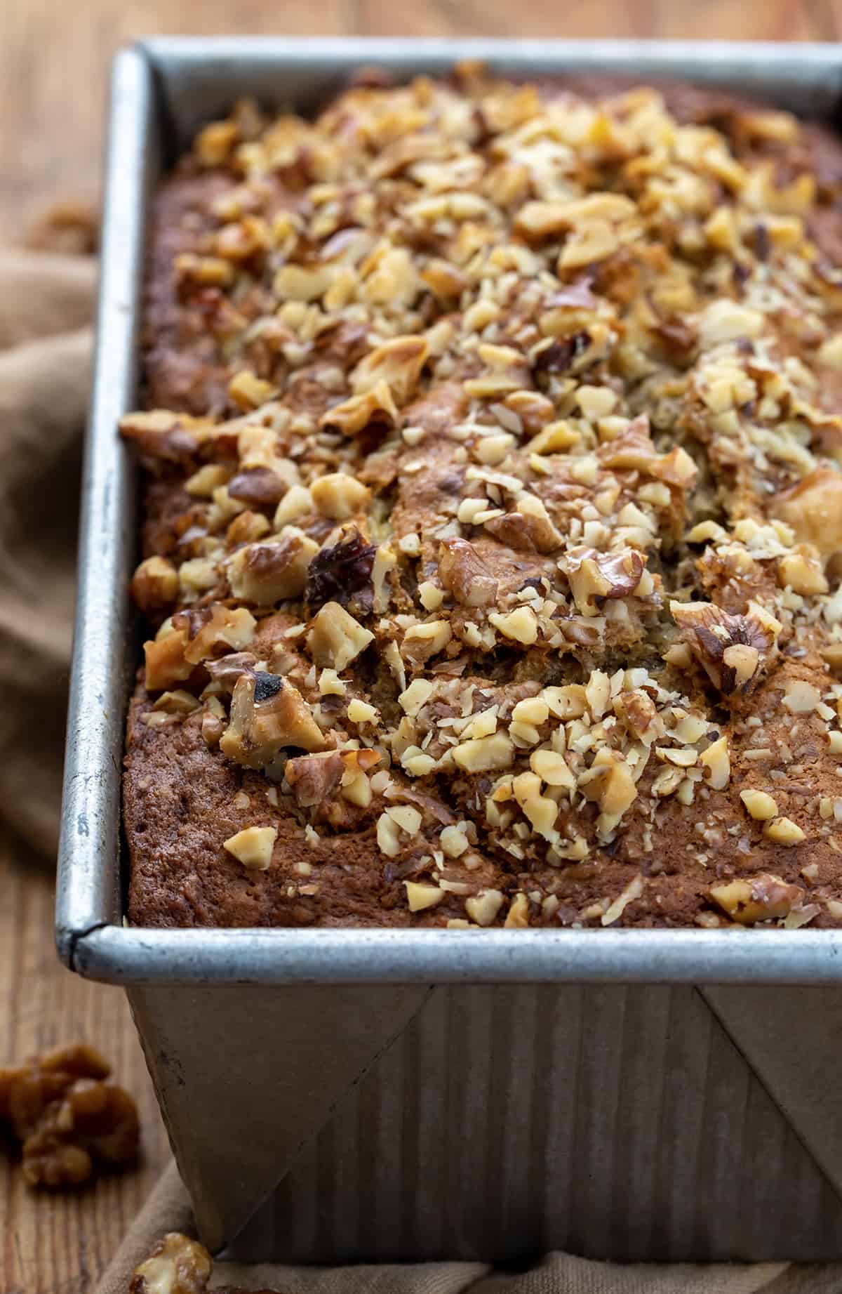 Close up of Brown Butter Banana Nut Bread in Pan on Butting Board.