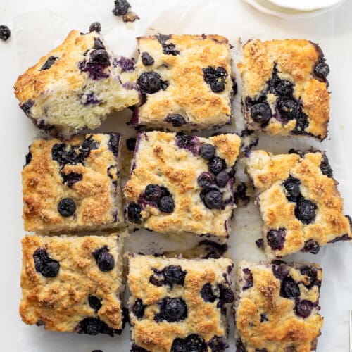 Blueberry Butter Swim Biscuits on a White Counter from Overhead and Cut Into Pieces.