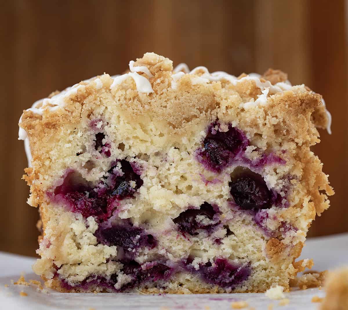 Loaf of Blueberry Lemon Bread Close up on a Cutting Board with Pieces Removed so The Inside Texture is Showing. 