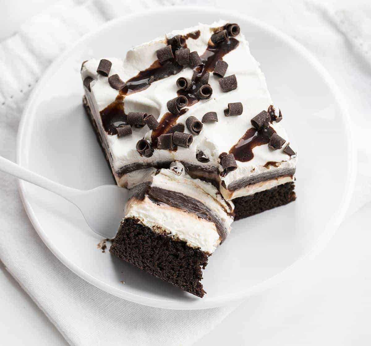 Forkful of Brownie Pudding Dessert on White Plate