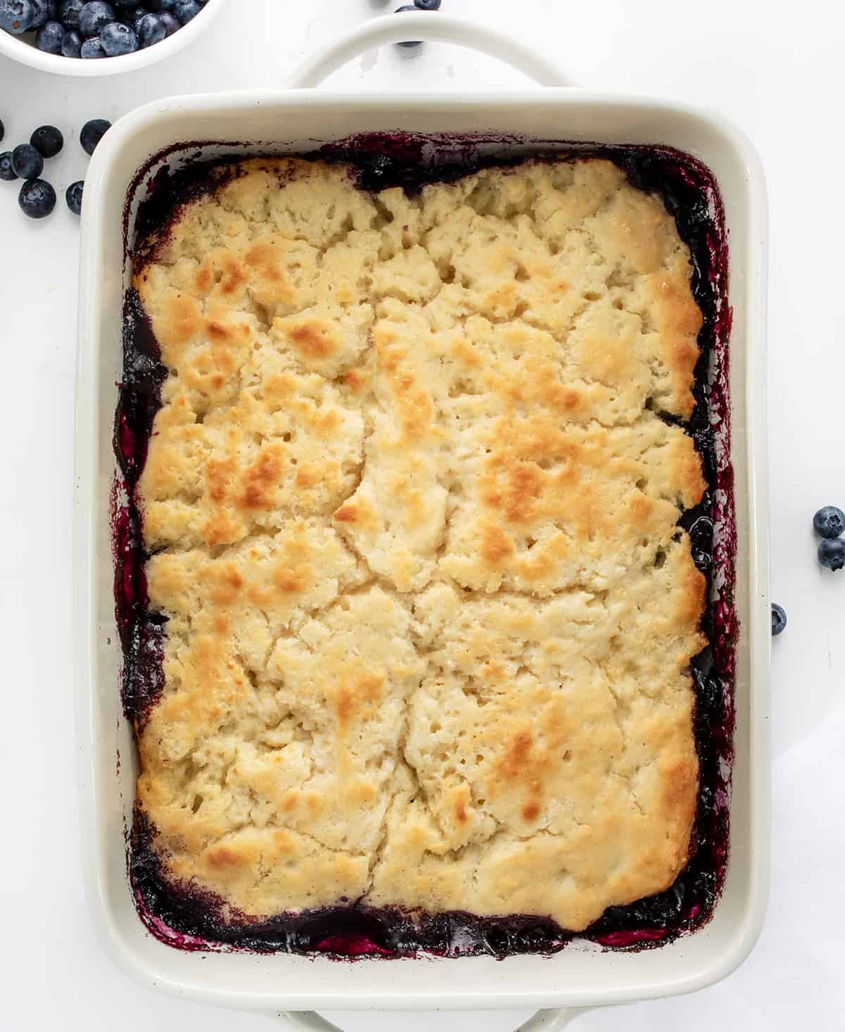 Pan of Butter Swim Biscuit Blueberry Cobbler with Fresh Blueberries.