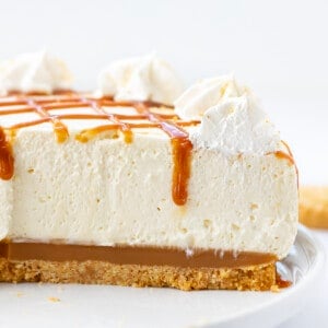 CLose up of a Sliced Into Caramel Cheesecake Showing the Inside Texture and a Bit a Caramel Dripping Down.