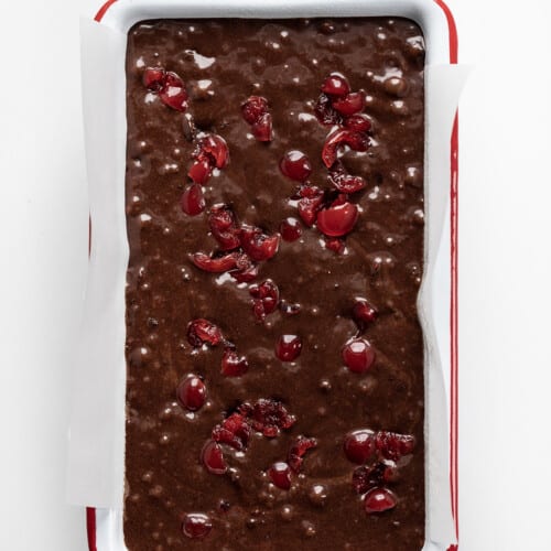 Raw Cherry Brownie Bread Batter in a Pan Showing Cherries.