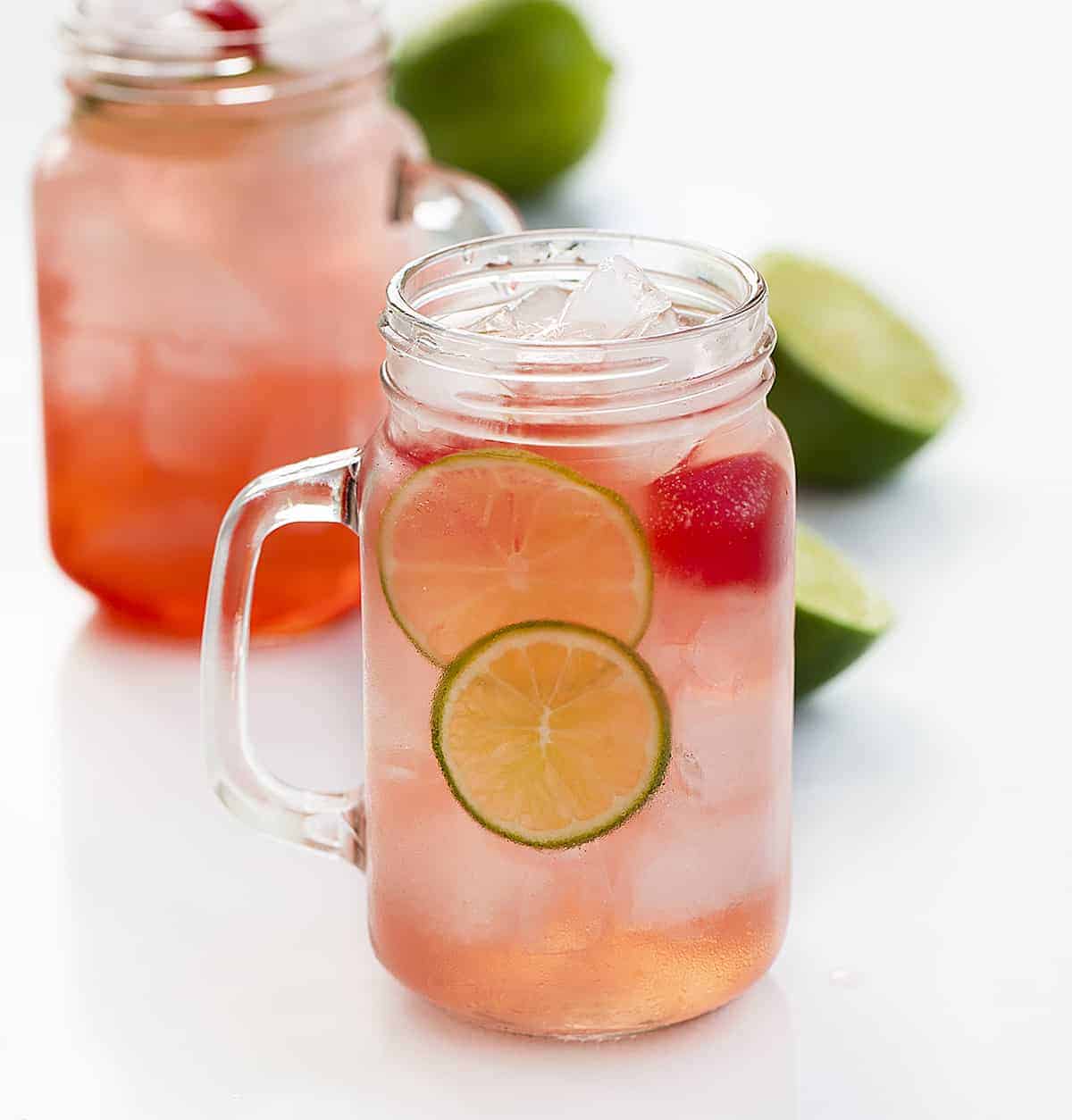 Two Glasses of Cherry Limeade Drink with Fresh Lime