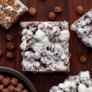 Cocoa Puff Bars on a Cutting Board with Cocoa puffs.