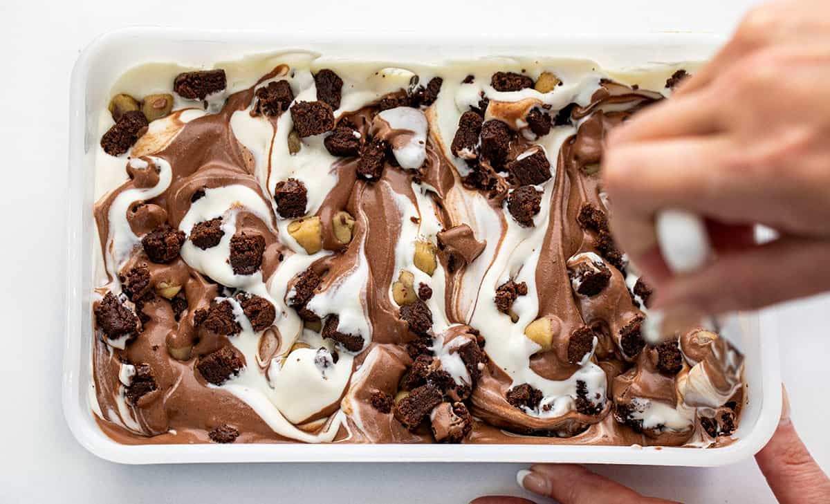 Stirring up Cookie Dough Brownie Ice Cream.