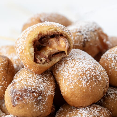 Stack of Deep Fried Snickers with One Bit Into.