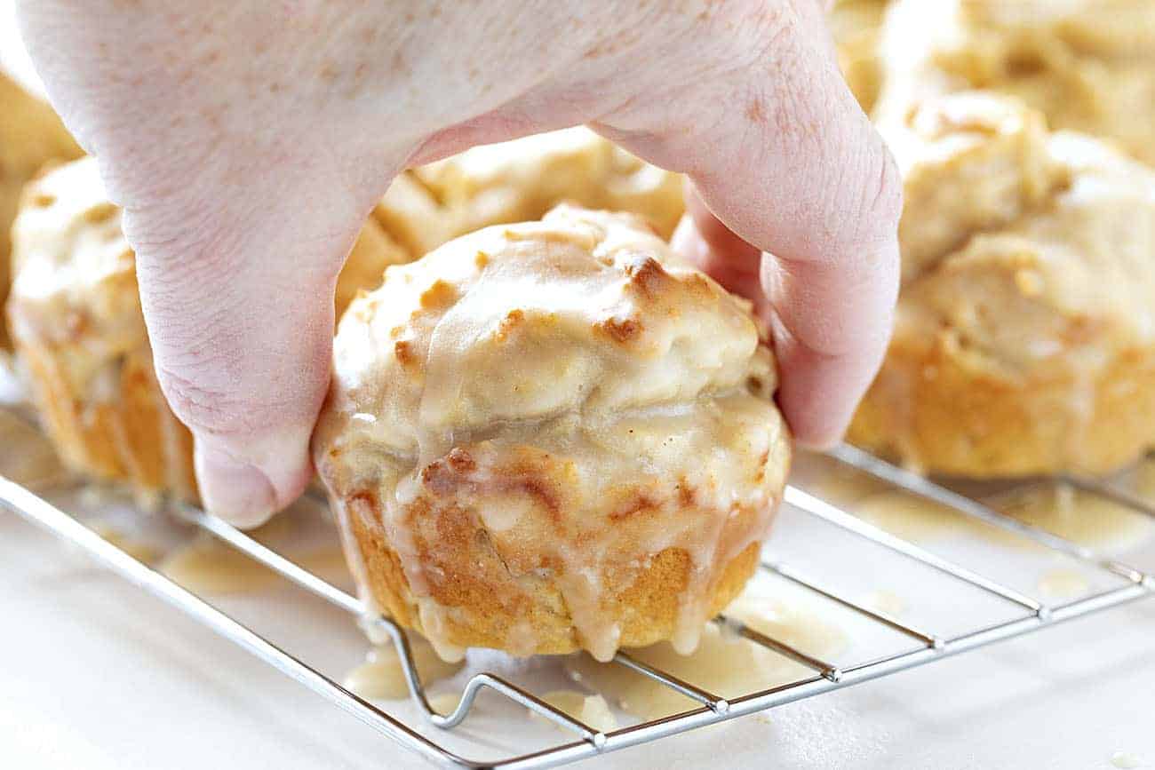 Hand picking up Old Fashioned Pumpkin Spice Donut Muffins