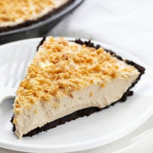 Piece of Easy Peanut Butter Pie on a White Plate with White Fork.