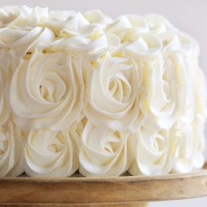 Stunning rosettes cover this flavorful cake... white cake layers complemented with rich fudgey brownie deliciousness!