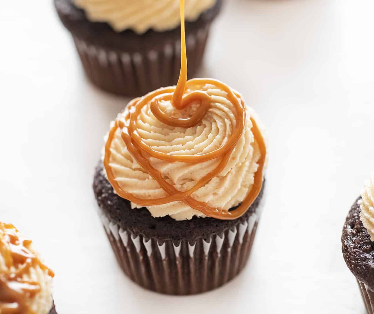 Chocolate Cupcakes with Salted Caramel Buttercream Being Piped On