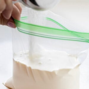 Adding Sugar to a Bag Filled with Heavy Cream to Make Soft Serve Ice Cream.