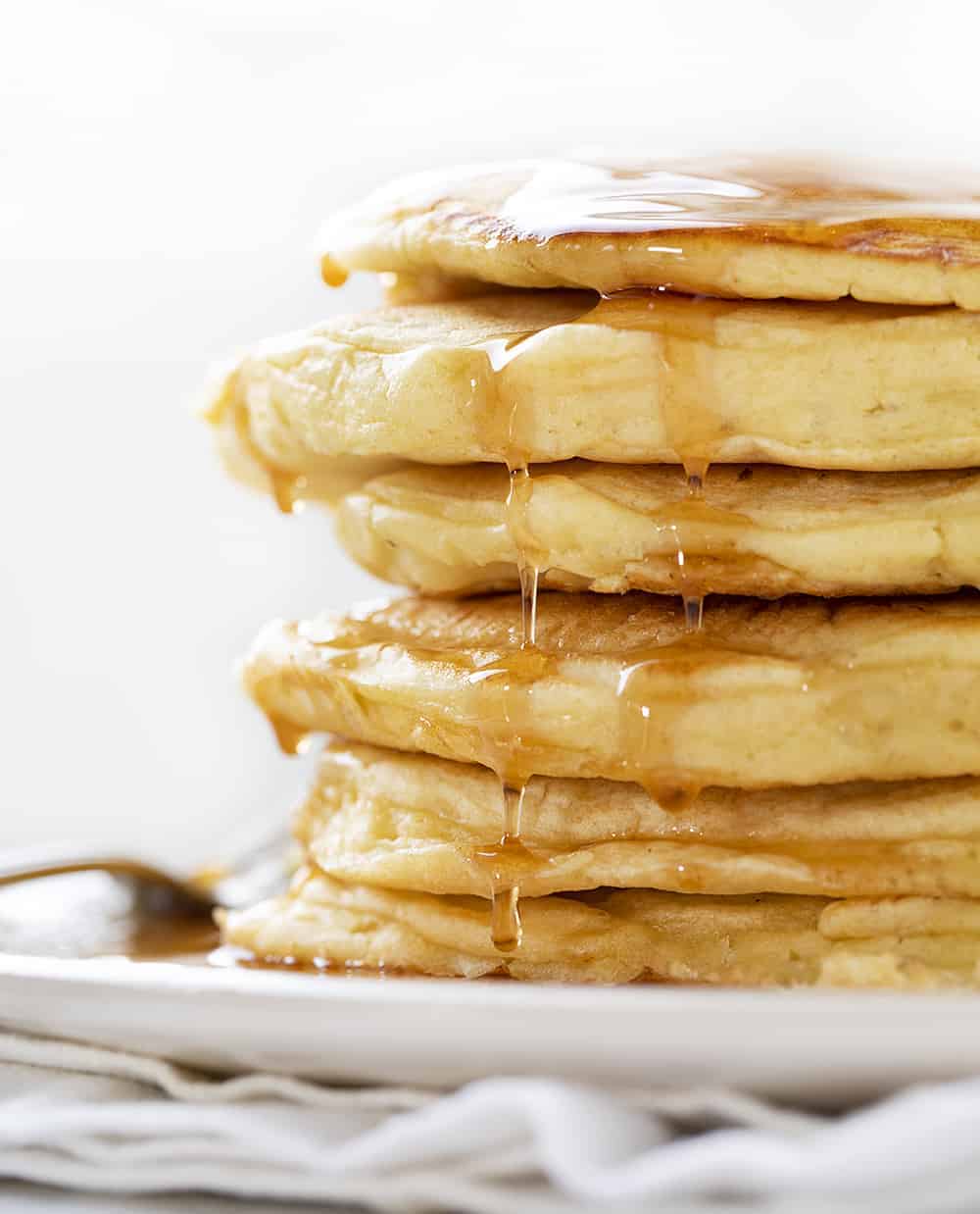 Straight on View of Sourdough Pancakes with Syrup Drizzling