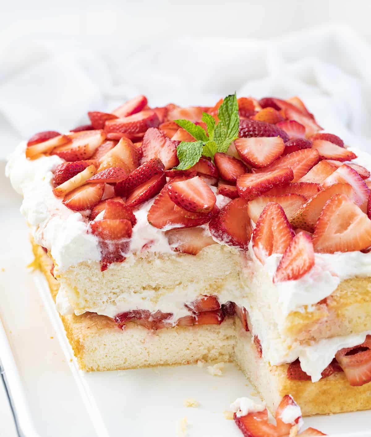 Cut Into Sheet Pan Strawberry Shortcake on a White Counter.