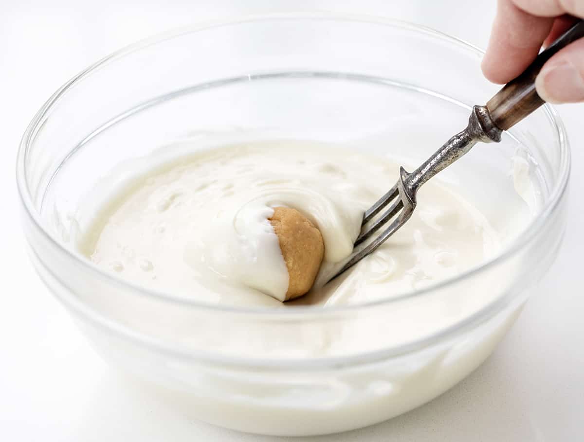 Rolling Sugar Cookie Dough into White Chocolate to Make Sugar Cookie Truffles.