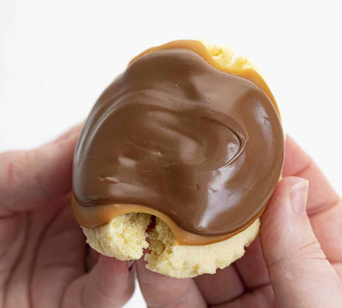 Hand Breaking Apart a Twix Inspired Cookie