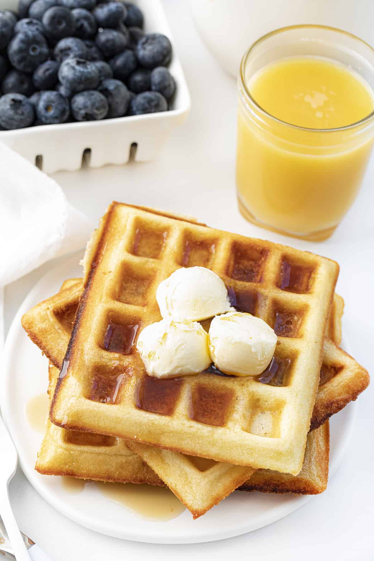 Waffles of Insane Greatness on Plate with Fruit and Butter